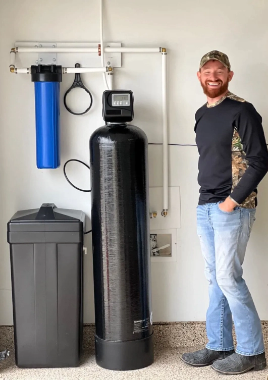 man with water softener system